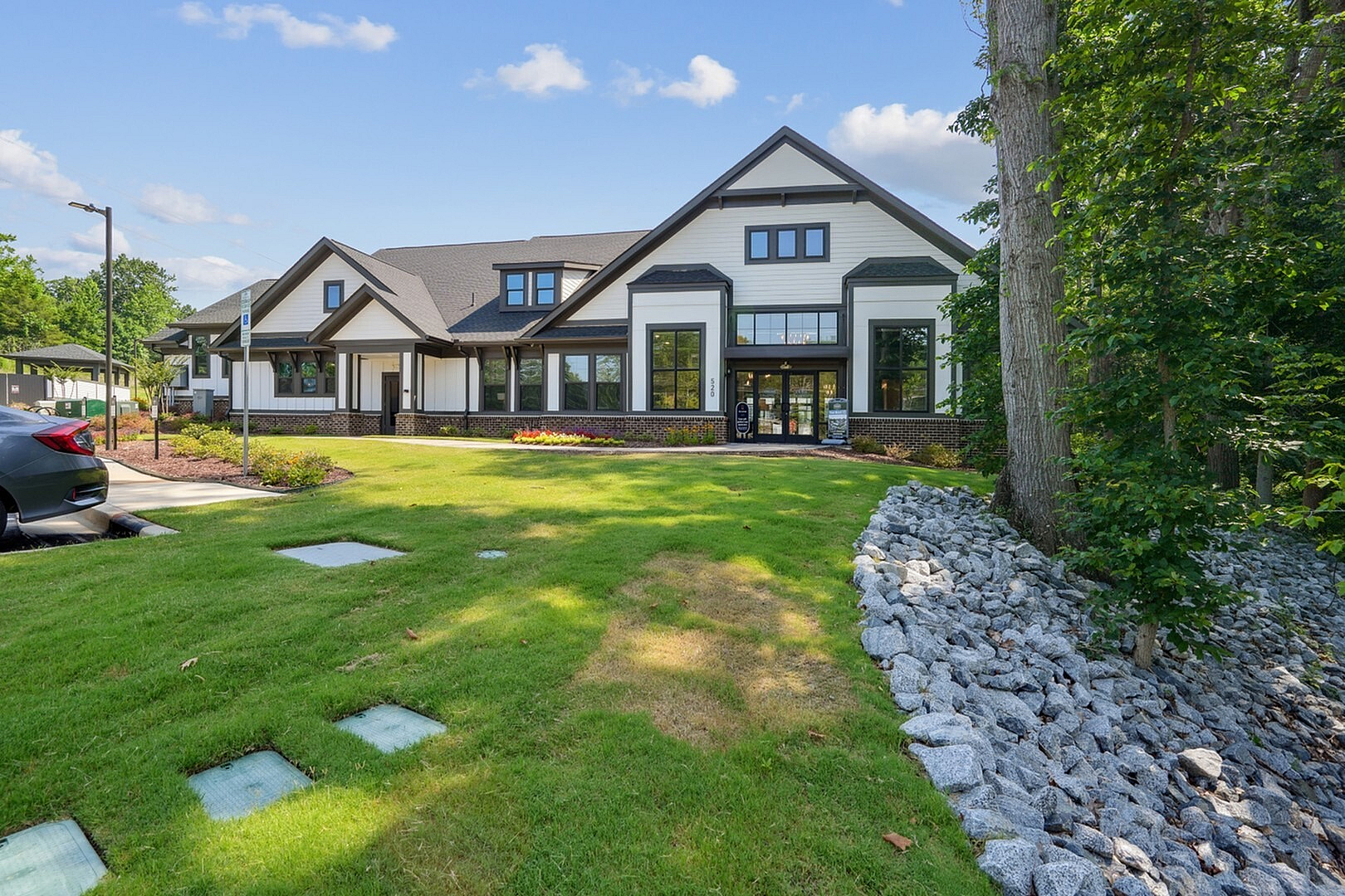 Charming modern home with stylish architecture, lush landscaping, and inviting entrance perfect for relaxed suburban living.