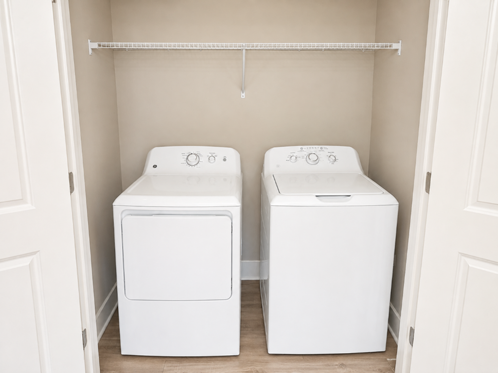 Modern laundry room with a pristine washer and dryer set, complemented by a sleek shelving unit.