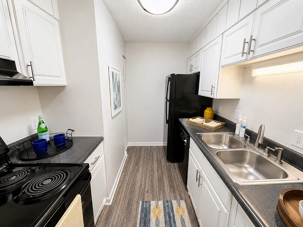 Sleek modern kitchen with stylish cabinets, dual sinks, and elegant lighting, perfect for cooking adventures.