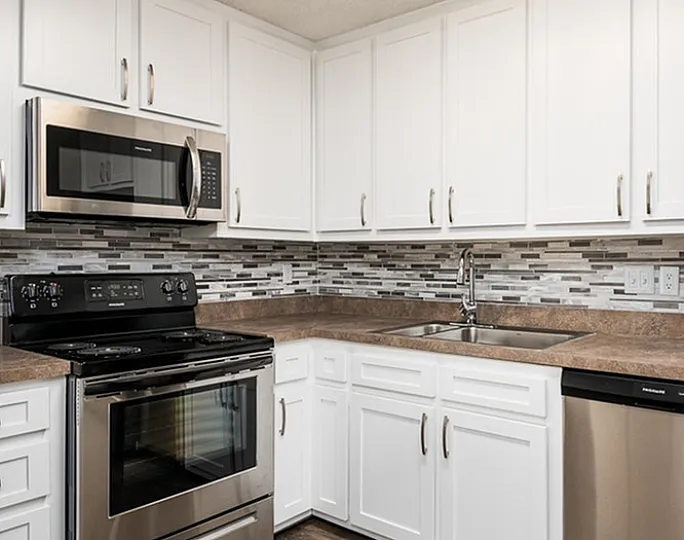 Modern kitchen with stainless steel appliances, white cabinetry, and stylish backsplash.