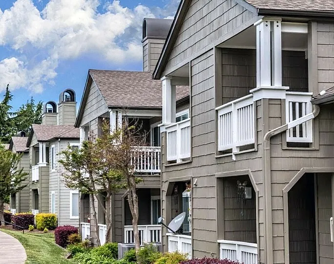 Inviting residential buildings with balconies in a serene community setting.