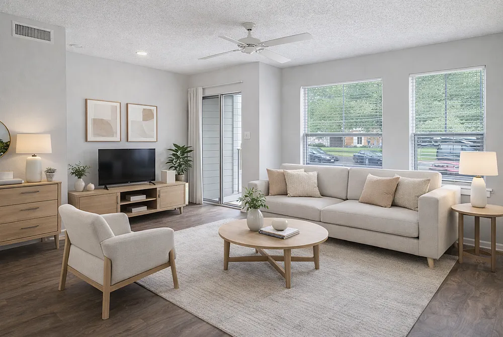 Bright and cozy living room featuring modern furniture, a neutral color palette, and large windows for natural light.