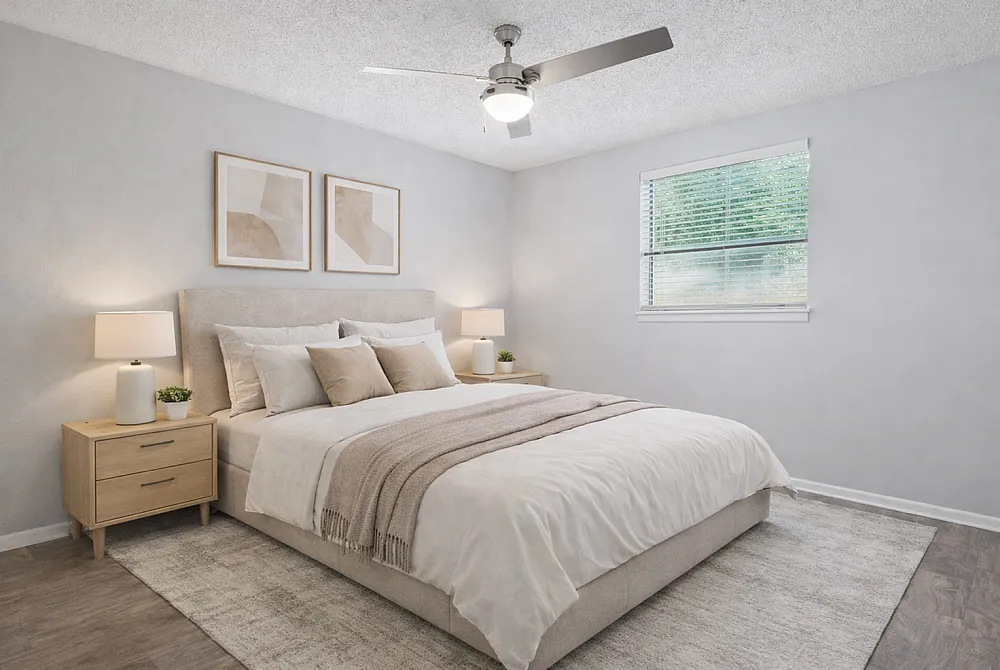 Elegant bedroom featuring a plush bed with neutral tones, stylish nightstands, and soft lighting for a serene atmosphere.