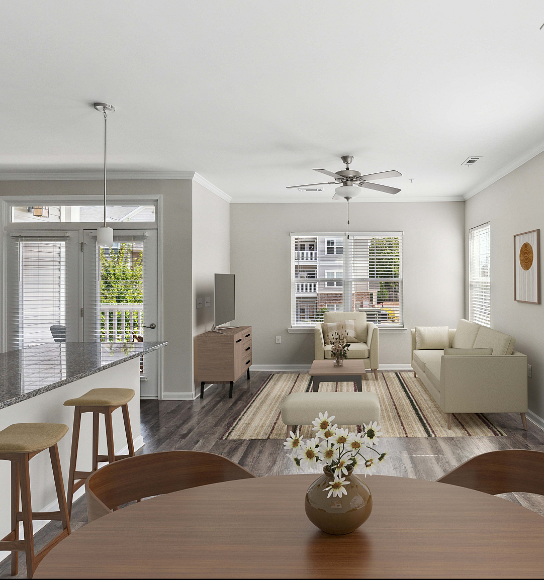 Bright, modern open-concept living room with stylish furnishings, a granite kitchen island, and large windows offering ample natural light.