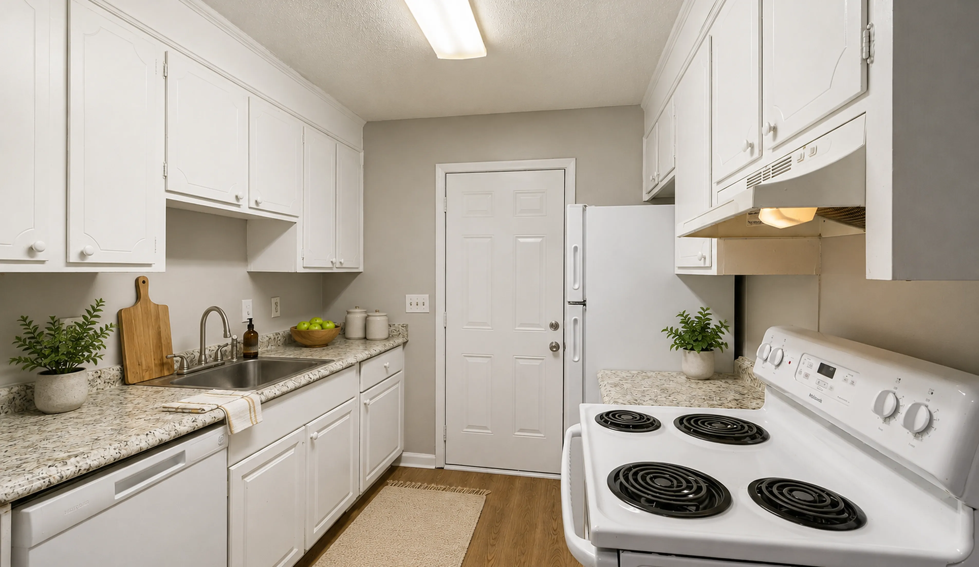 Charming modern kitchen with sleek white cabinetry, elegant countertops, and stainless steel appliances, perfect for culinary inspiration.