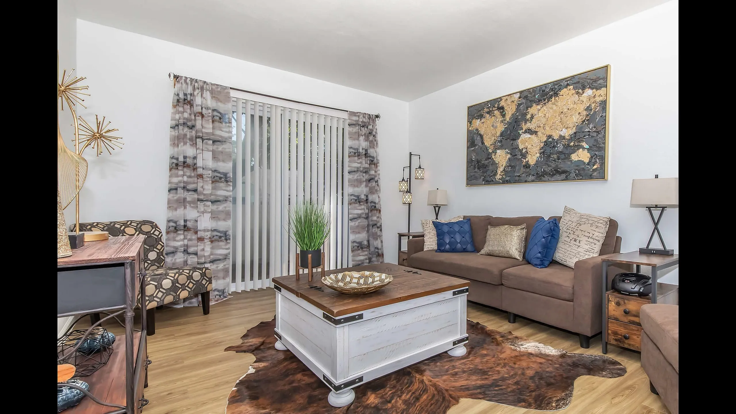 Chic living room with a cozy brown sofa, stylish coffee table, and elegant decor, featuring modern art and ambient lighting.