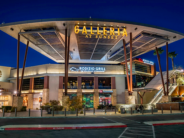 Vibrant night view of Galleria at Sunset, highlighting modern architectural design with illuminated signage and upscale shopping mall ambiance.