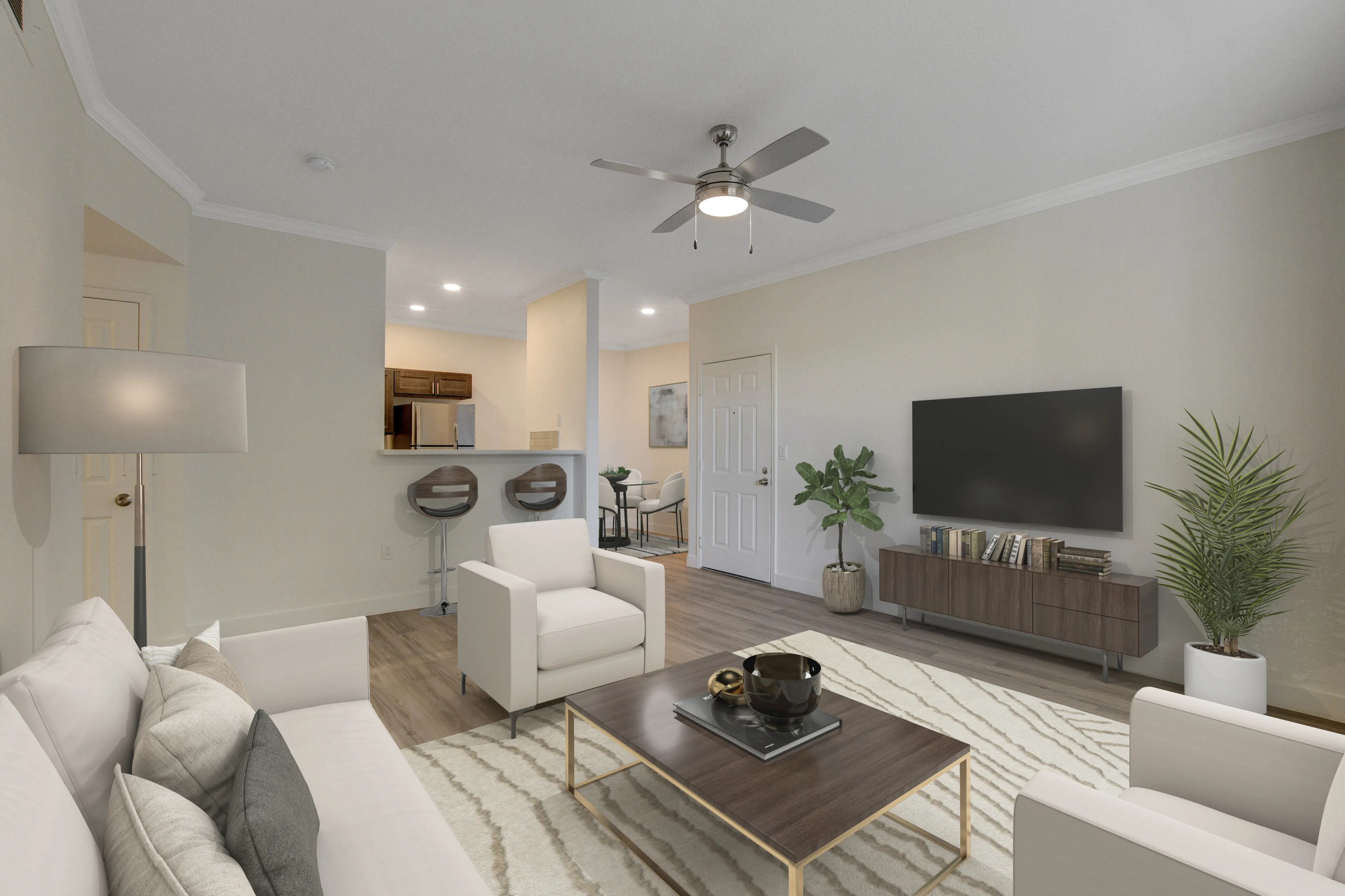 Inviting modern living room with stylish decor, featuring a comfortable seating area, sleek ceiling fan, hardwood floors, and open view into a chic kitchen with bar stools.