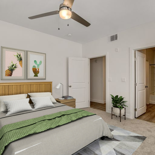 Inviting bedroom with modern decor, featuring a comfortable bed, stylish artwork, and a sleek ceiling fan.