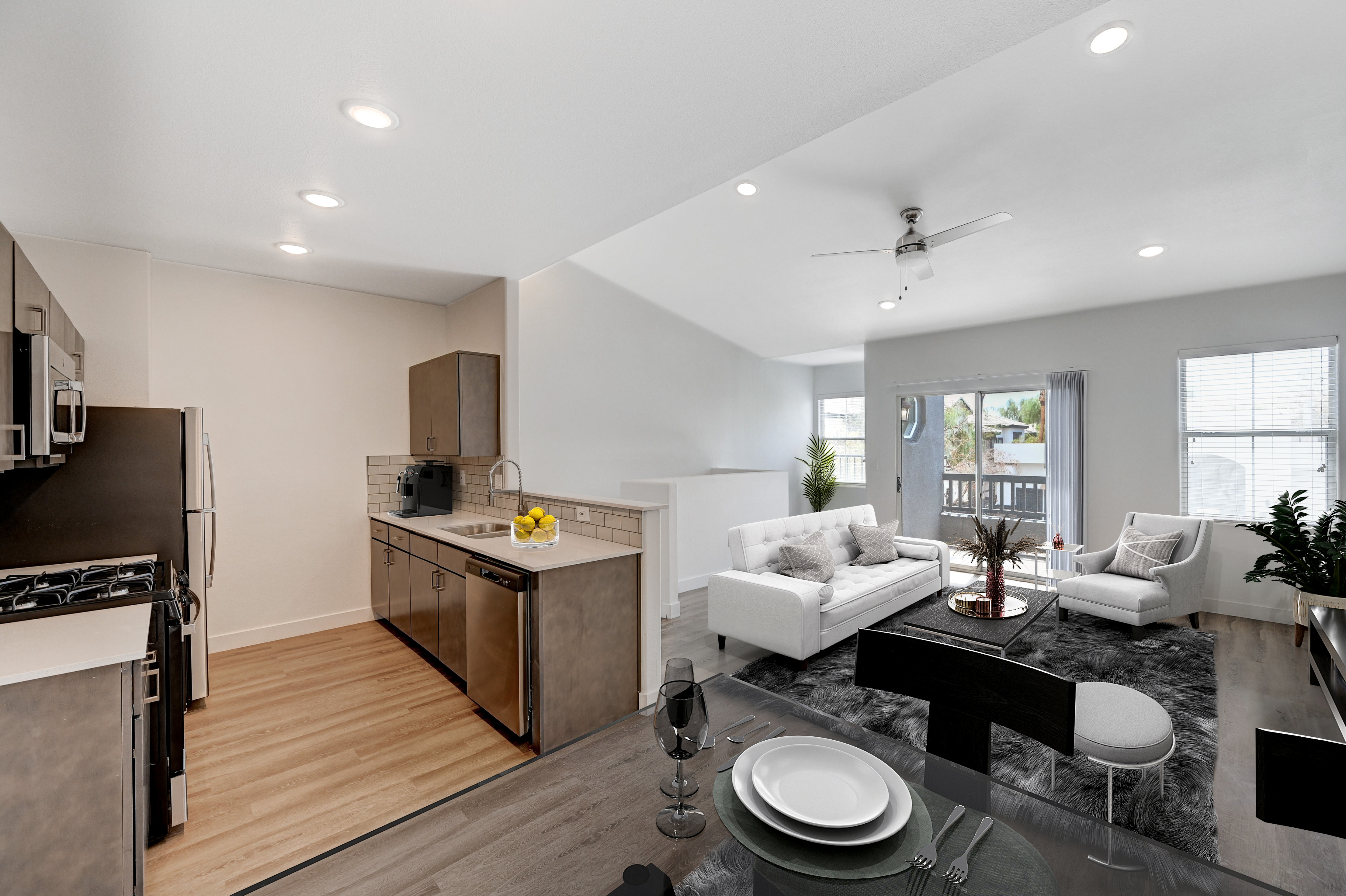 Modern open-concept kitchen and living area with sleek appliances, elegant decor, and natural light. A cozy yet spacious home perfect for stylish living.