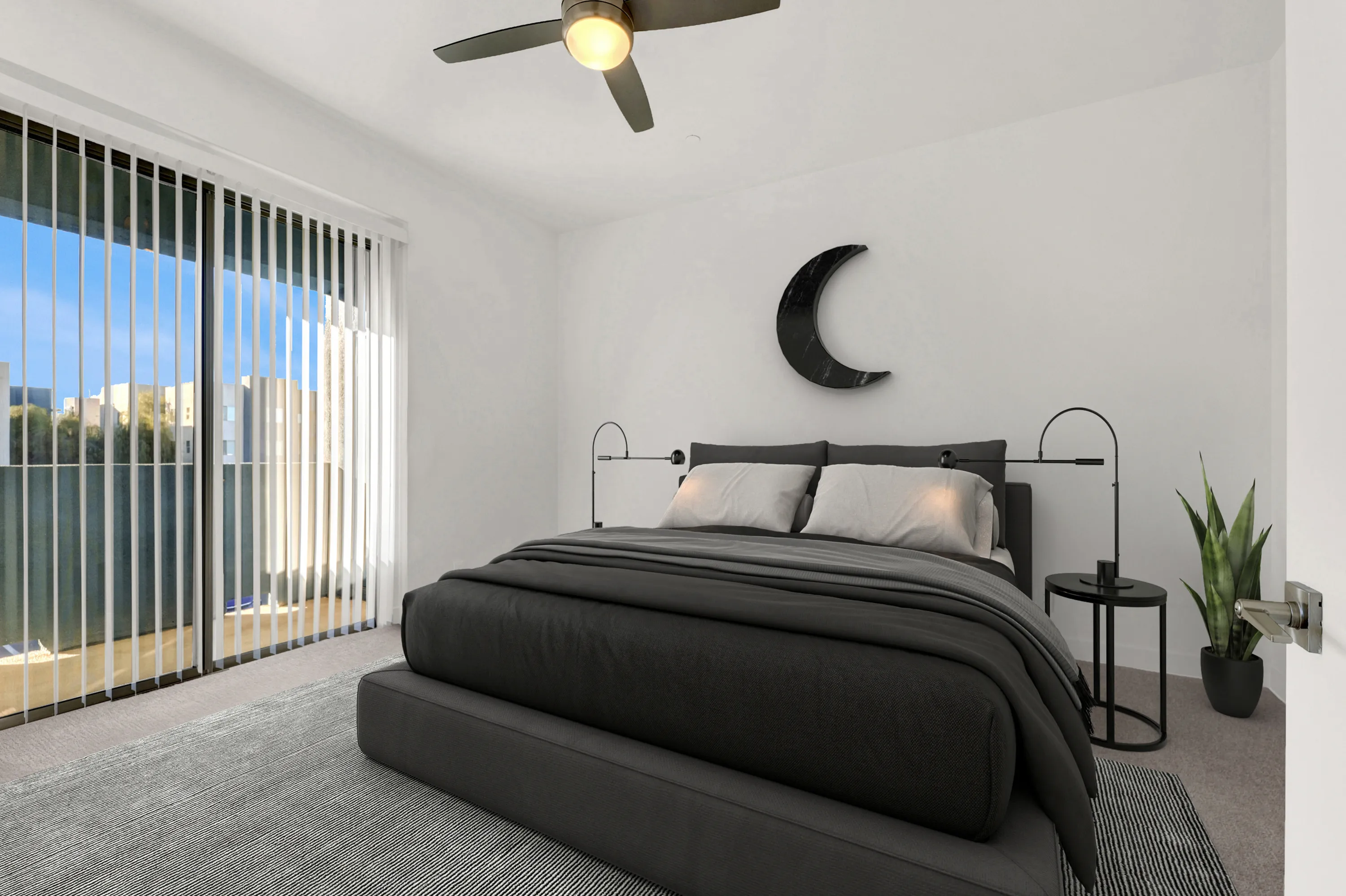 Modern bedroom with sleek decor, featuring a plush double bed, stylish moon wall art, and a serene view through large sliding glass doors.