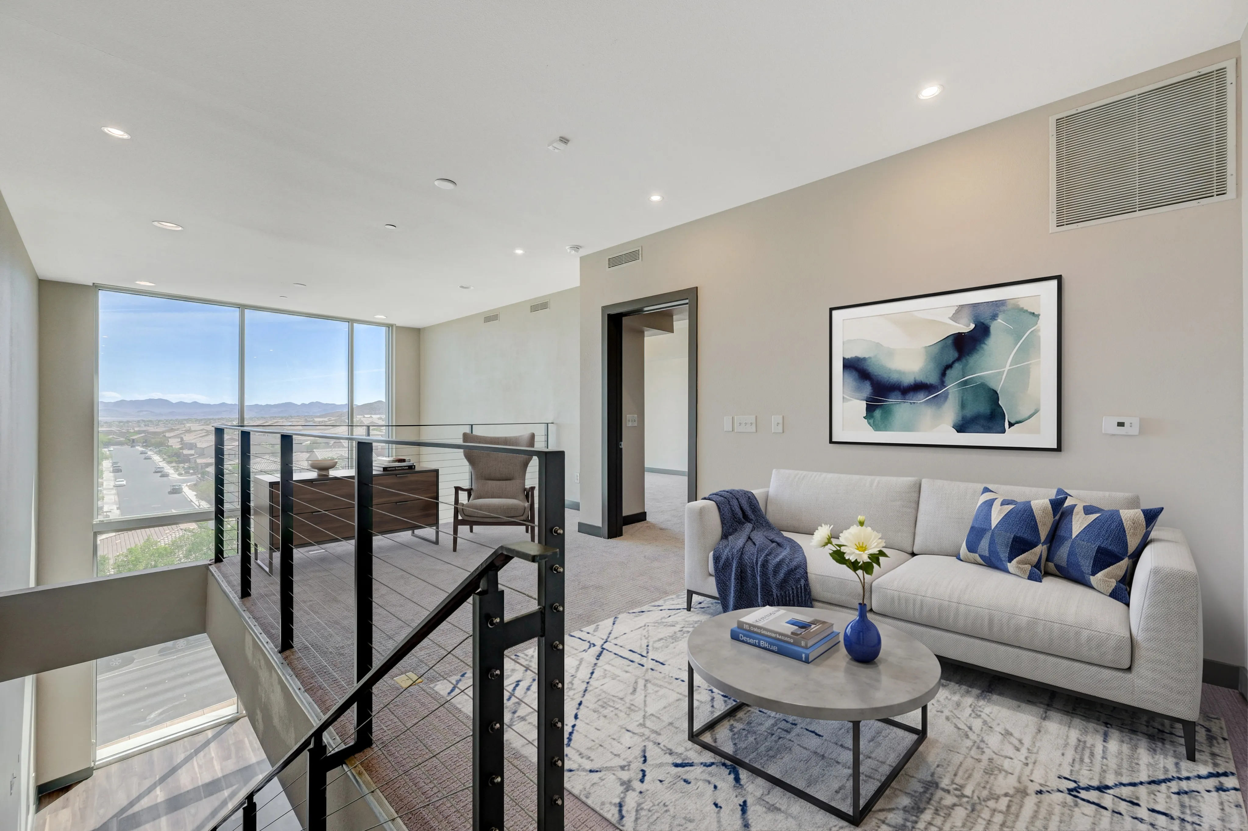 Bright and modern living area with panoramic city views, stylish décor, and cozy seating arrangement.