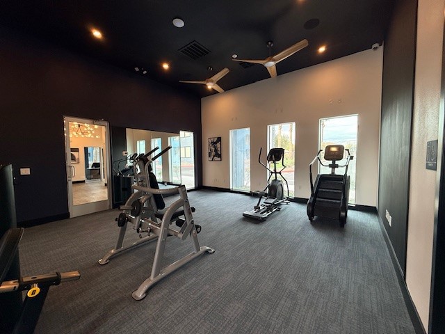 Modern fitness center with sleek exercise equipment and natural light from large windows.
