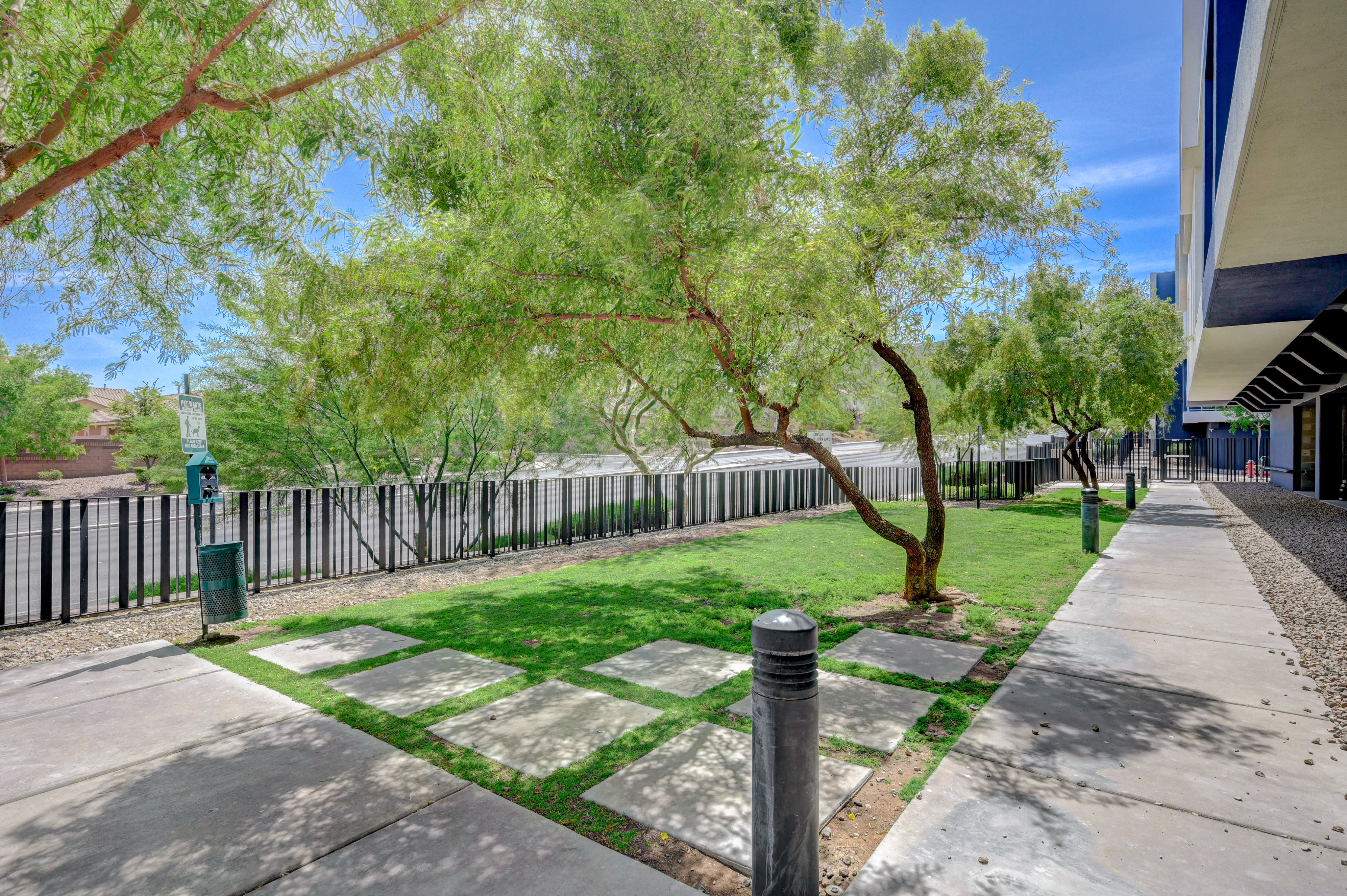 Inviting outdoor space with lush greenery and modern stone pathway, perfect for relaxation and enjoying nature.