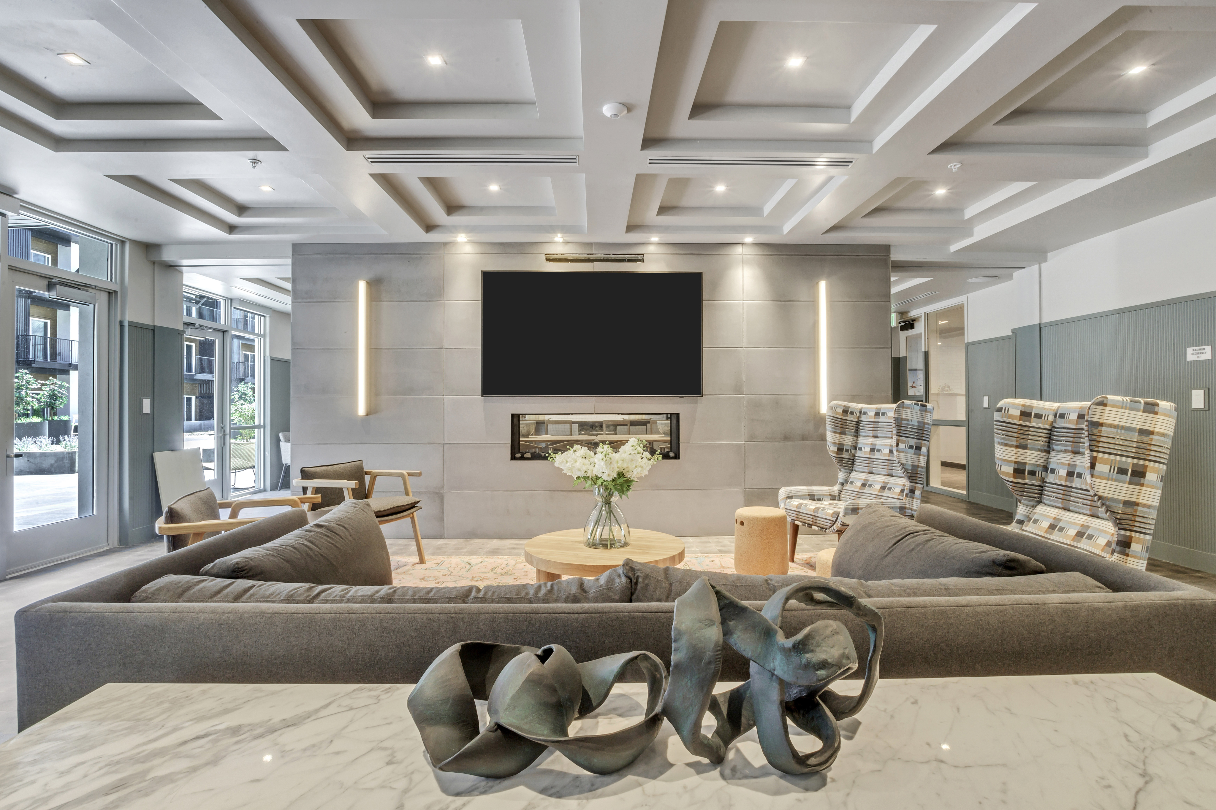 Luxurious modern lounge with chic seating, ambient lighting, and a sleek fireplace perfect for relaxation.