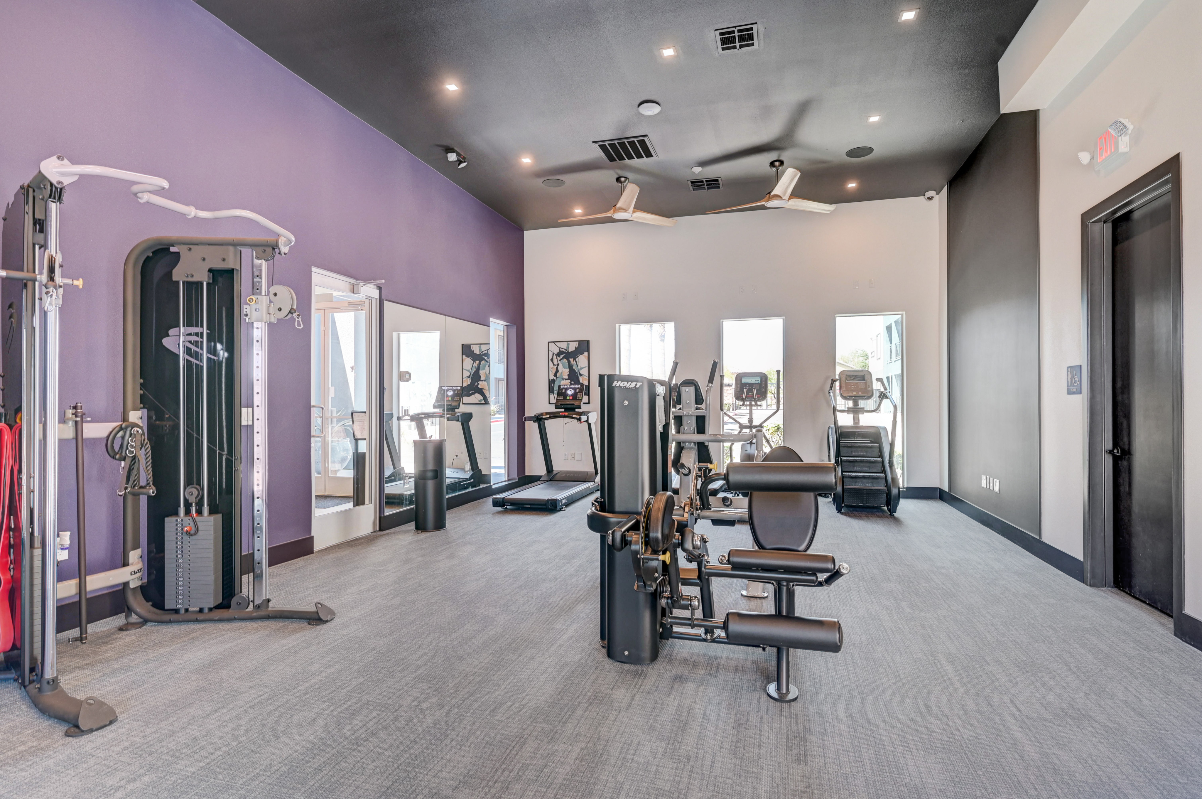 Modern fitness center with state-of-the-art exercise equipment and vibrant decor, offering an energizing workout environment.
