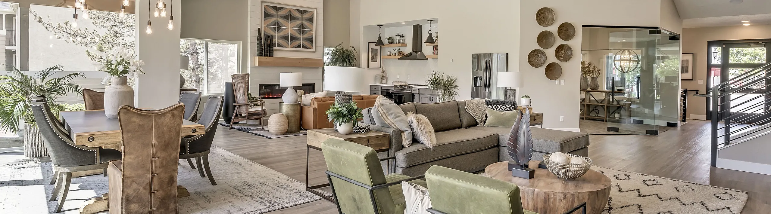 Spacious open-concept living and dining area with elegant decor, featuring modern furniture, stylish lighting, and abundant natural light.