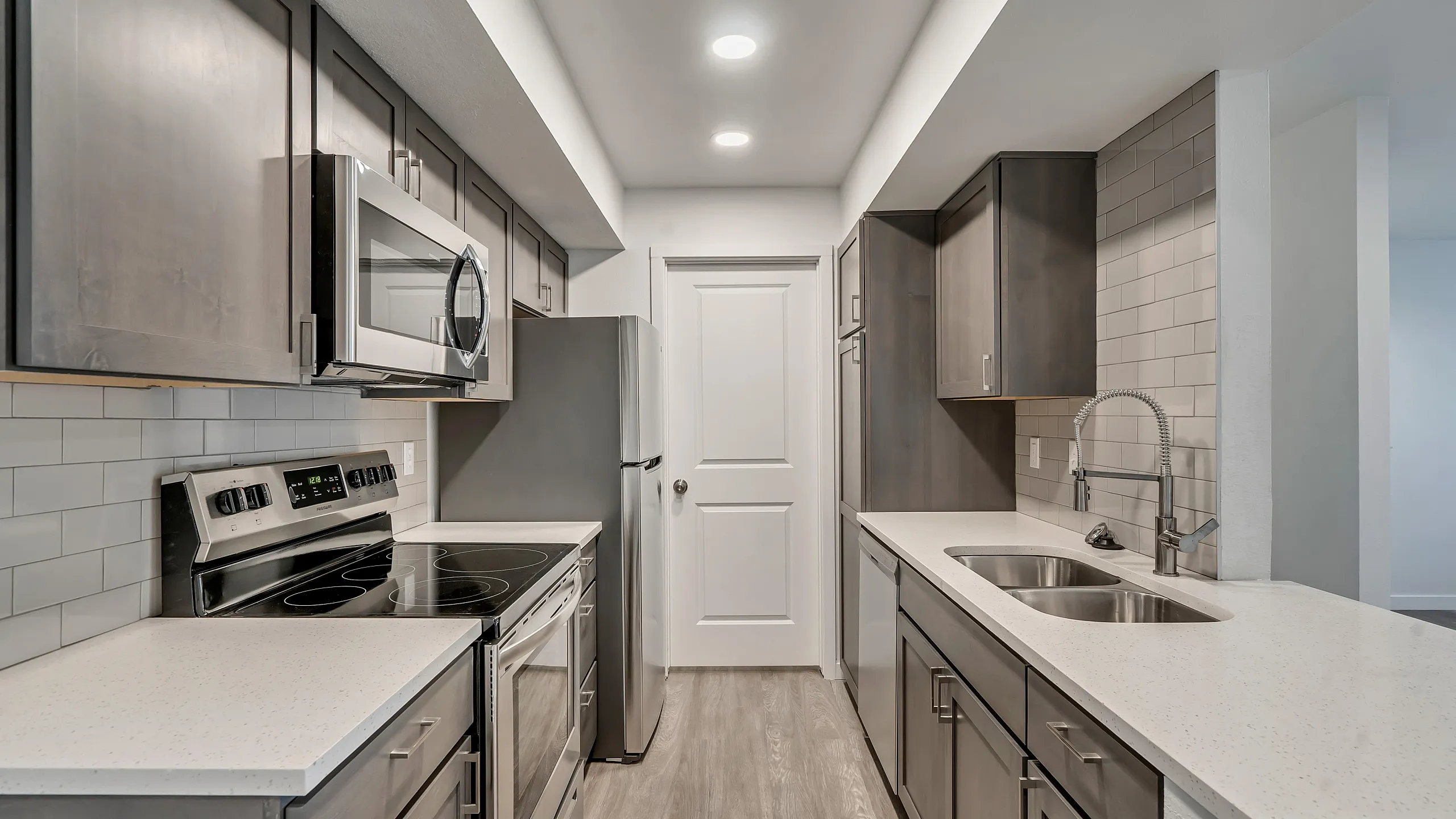 Sleek modern kitchen featuring stainless steel appliances, elegant cabinetry, and a bright, minimalist design.