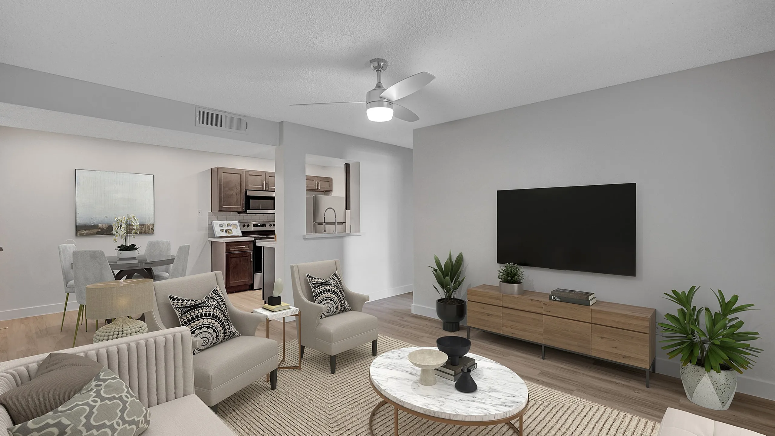 Modern living room with elegant decor, featuring a cozy seating area, large TV, and open-access kitchen for effortless entertaining.