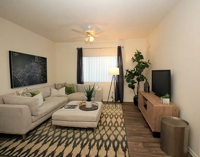 Elegant living room with plush corner sofa, stylish decor, warm lighting, and a contemporary media console.