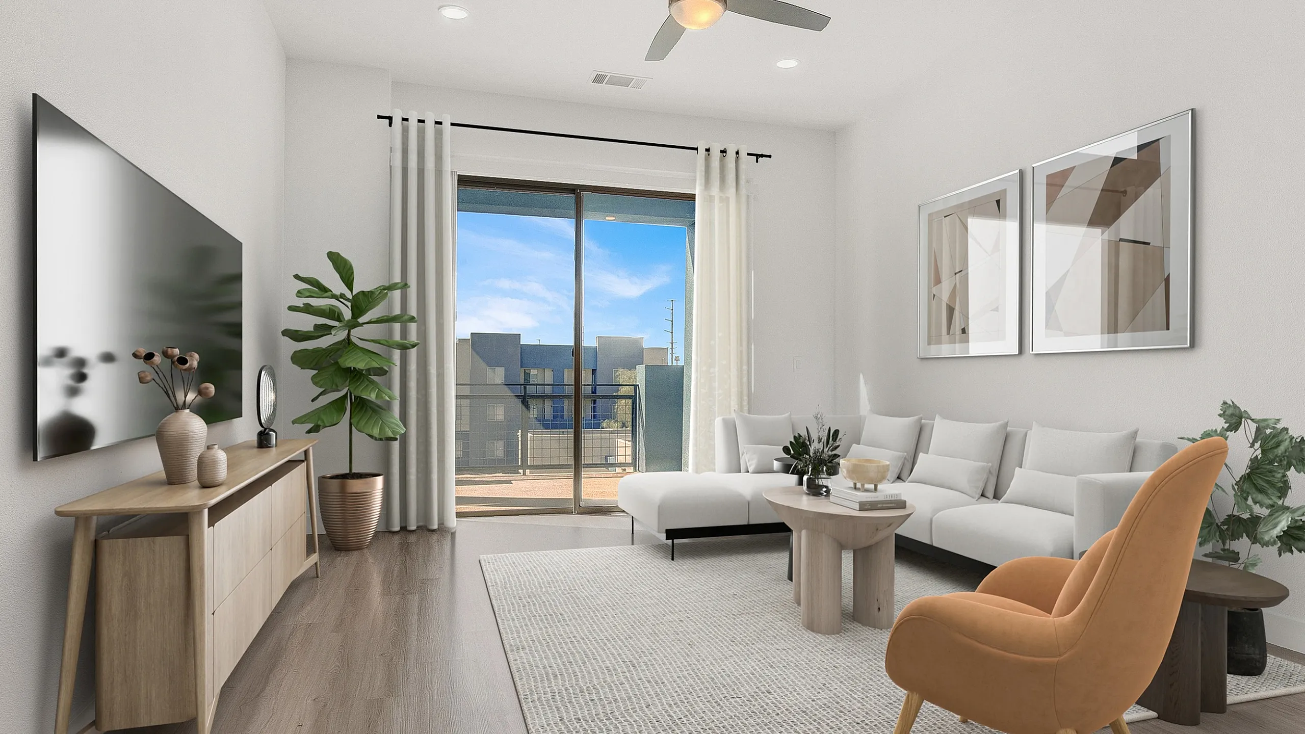 Modern living room with elegant decor, featuring a white sectional sofa, large flat-screen TV, and natural light from sliding doors leading to a balcony.
