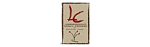 Elegant sign for Legacy Crossing at Parrish Lane with artistic red accents and floral design.
