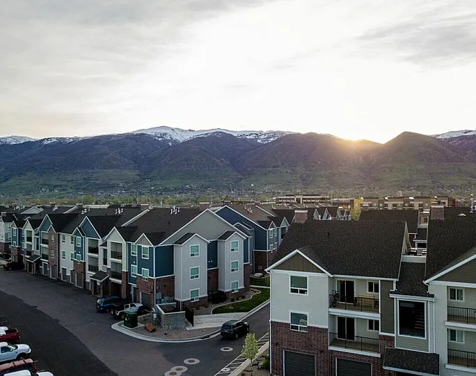 Charming residential complex with picturesque mountain views, featuring modern apartments and ample parking.