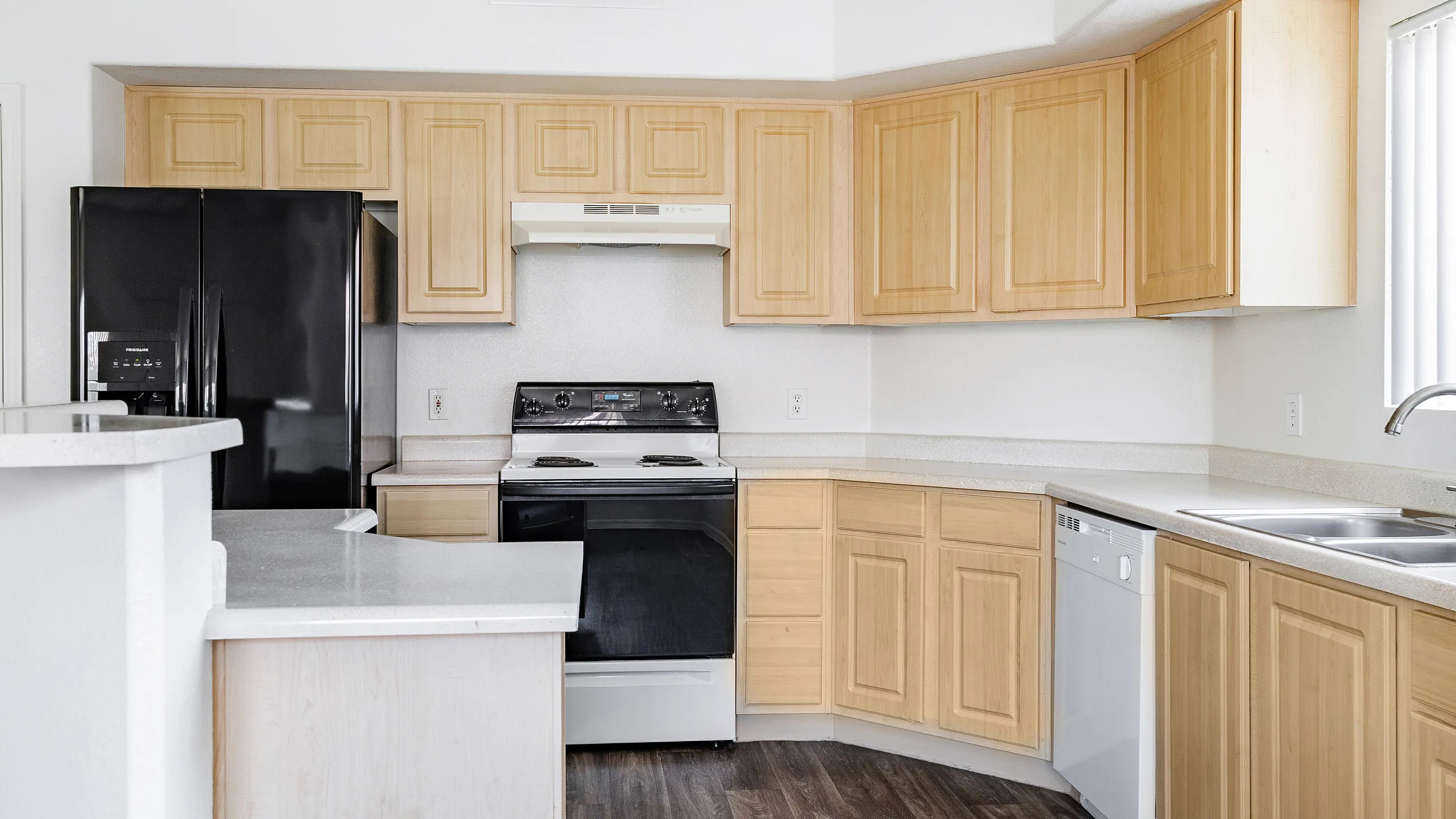 Bright and modern kitchen with sleek appliances, ample wooden cabinetry, and elegant countertops, perfect for culinary enthusiasts.