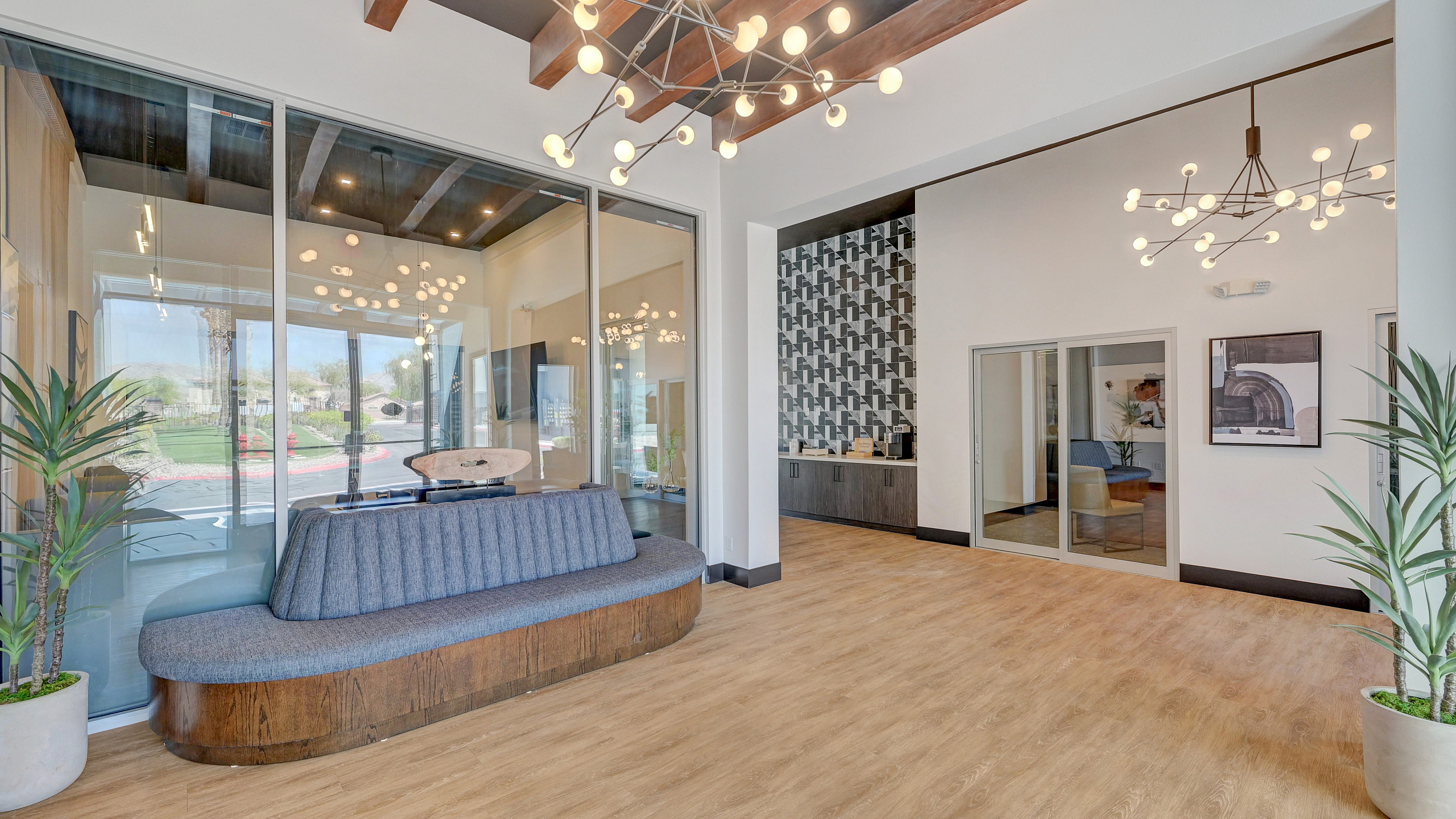 Modern lobby with stylish lighting, wooden accents, and comfortable seating, offering a warm and inviting atmosphere.