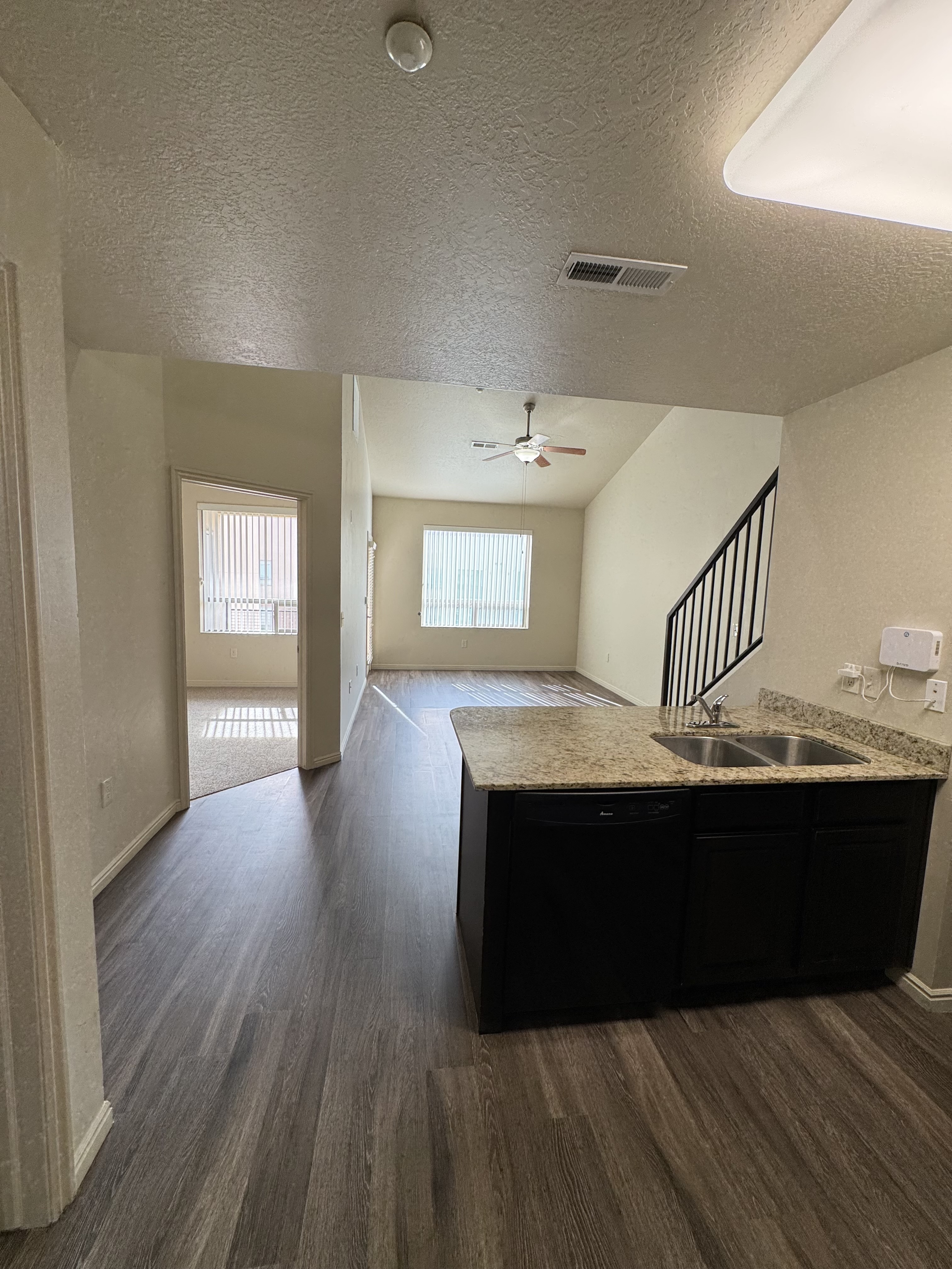 Bright and spacious apartment featuring elegant wooden flooring, modern kitchen with granite countertops, and an inviting open-plan layout.