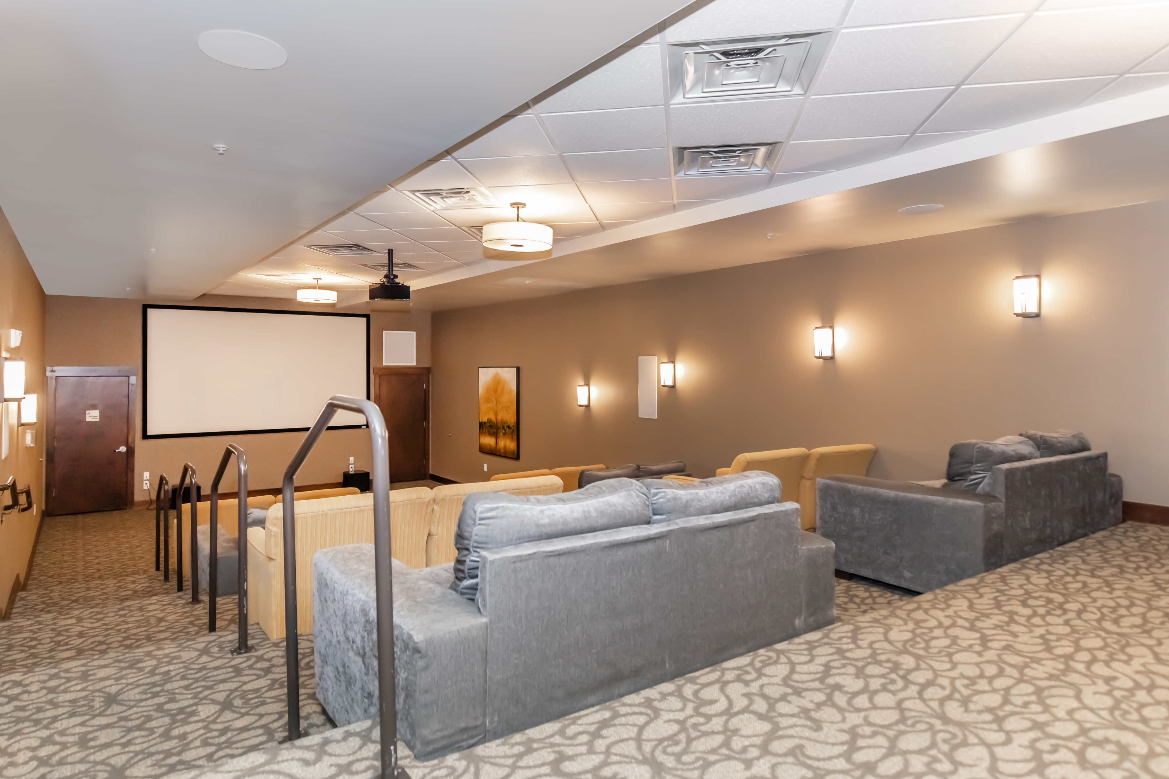 Luxurious residential theater room with plush seating and ambient lighting, ideal for movie nights.