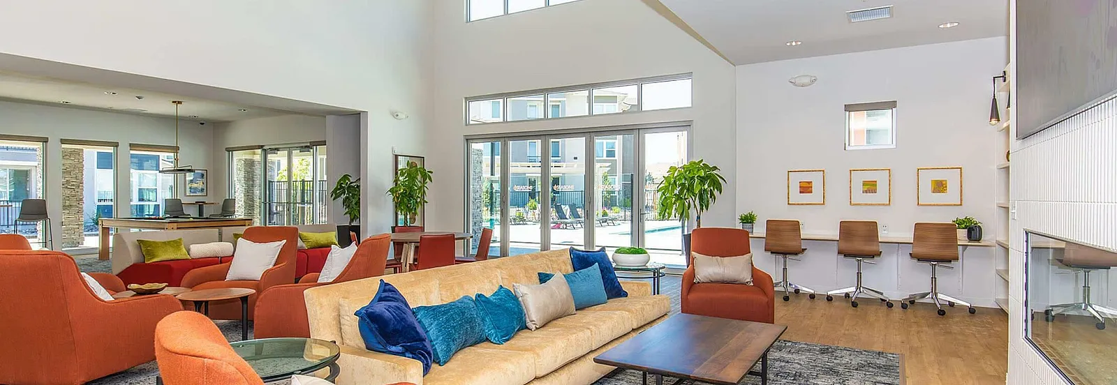 Bright and inviting living space with modern decor, plush seating, and large windows offering natural light.