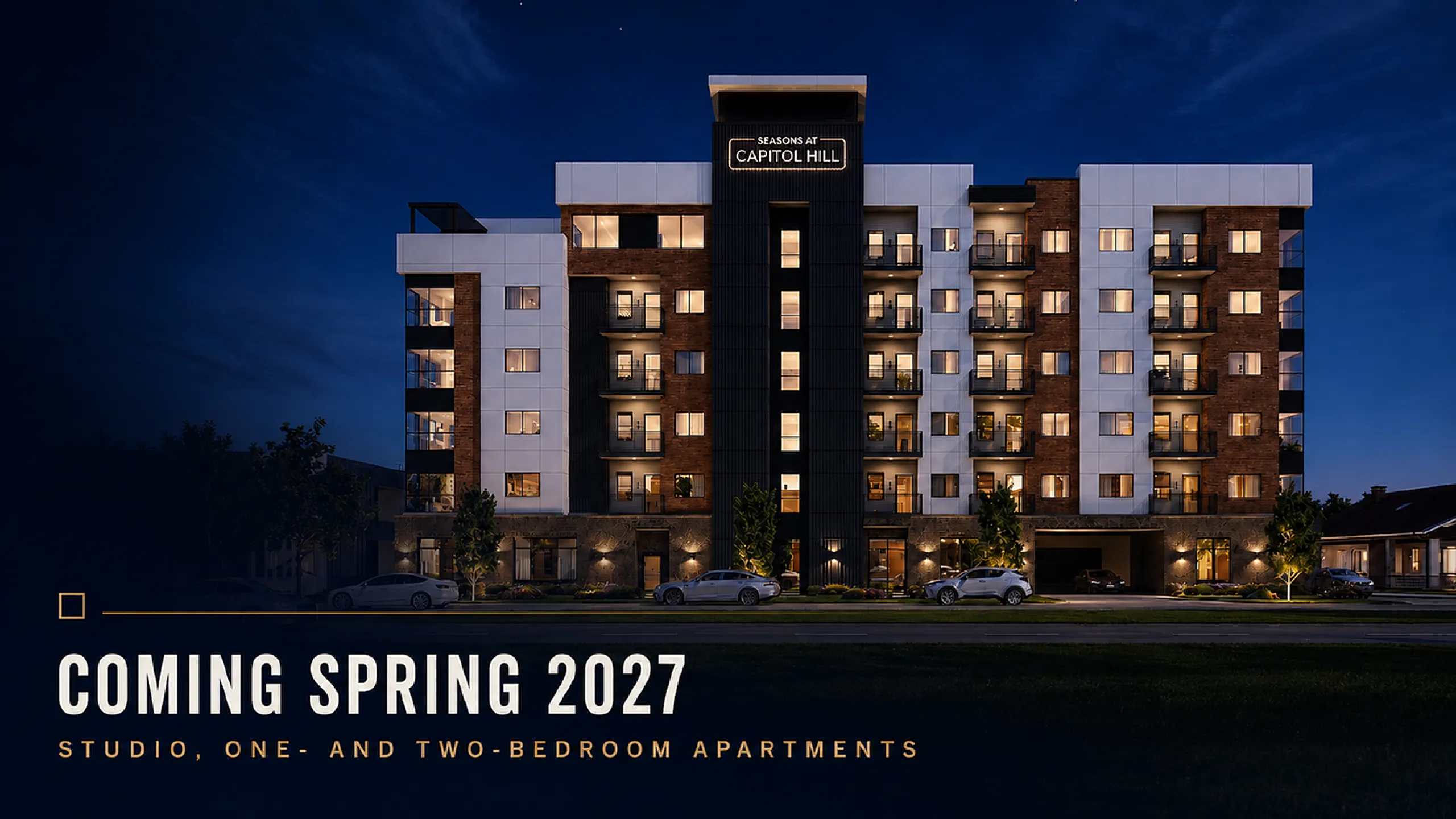 Elegant view of Seasons at Capitol Hill, a modern multi-story apartment building with illuminated windows, set to open Spring 2027 offering studio, one- and two-bedroom apartments.