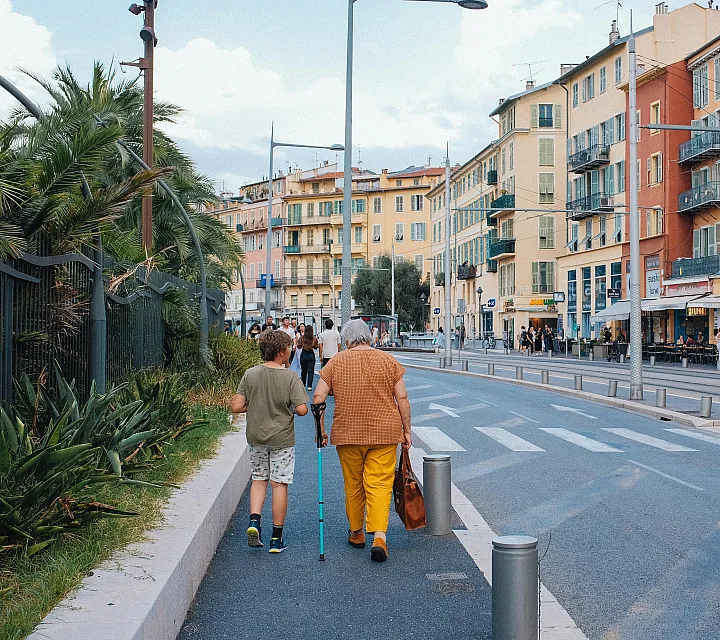 Charming European street scene with colorful buildings, vibrant shops, and lush greenery, creating an inviting urban atmosphere.