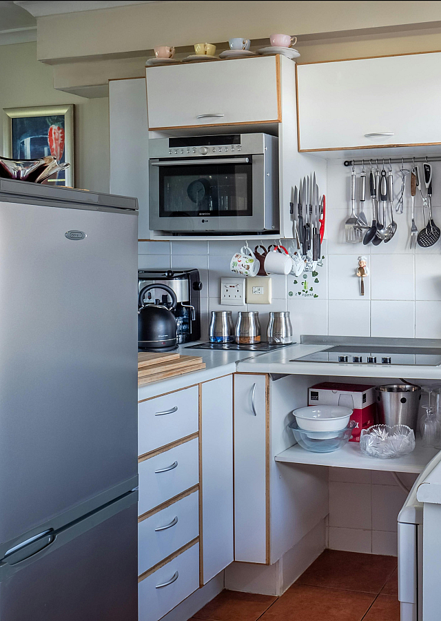 Chic kitchen with modern appliances, sleek cabinetry, and abundant natural light, perfect for culinary creativity.