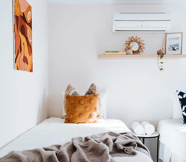 Inviting bedroom with cozy twin beds, stylish decor, and soft lighting creating a serene atmosphere.