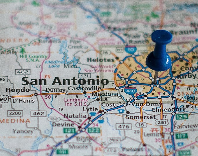 Close-up of a vibrant map highlighting San Antonio with a blue pushpin marking a key location.