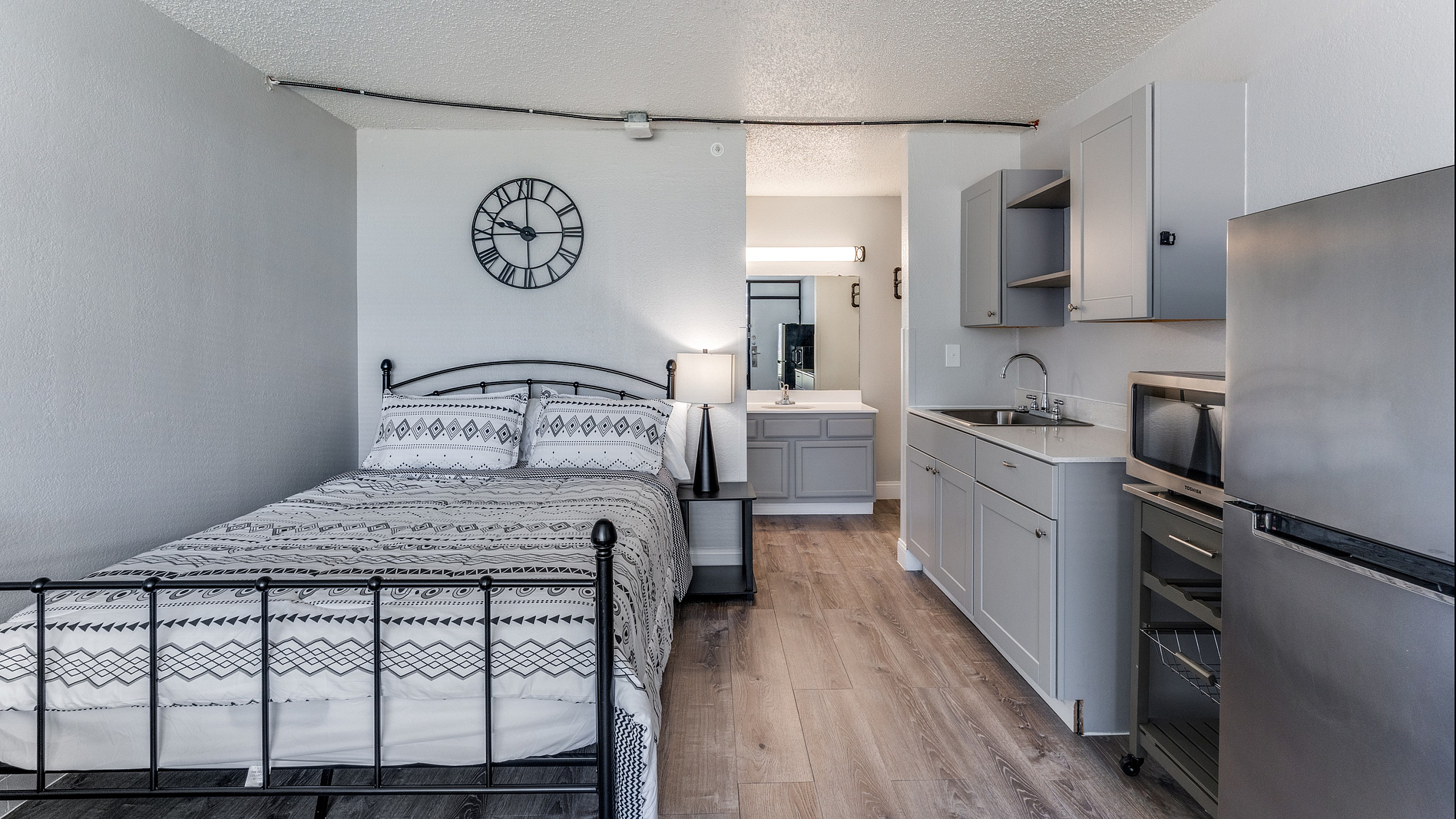 Charming studio apartment with cozy sleeping area, modern kitchenette, and stylish decor.