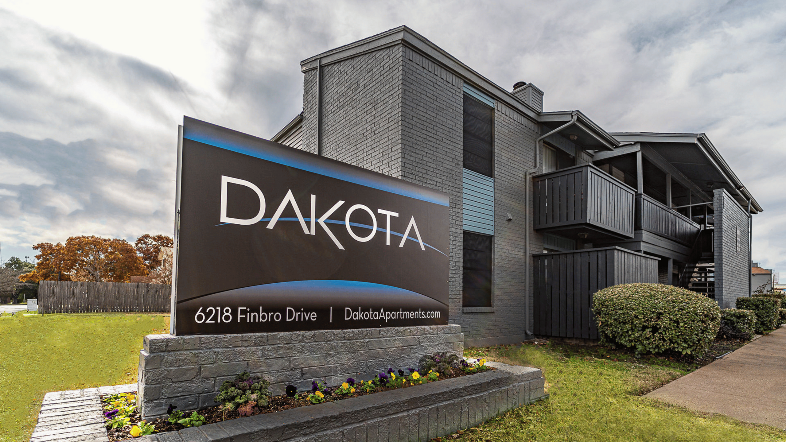 Contemporary apartment complex with sleek design and inviting outdoor spaces located on 6218 Finbro Drive.