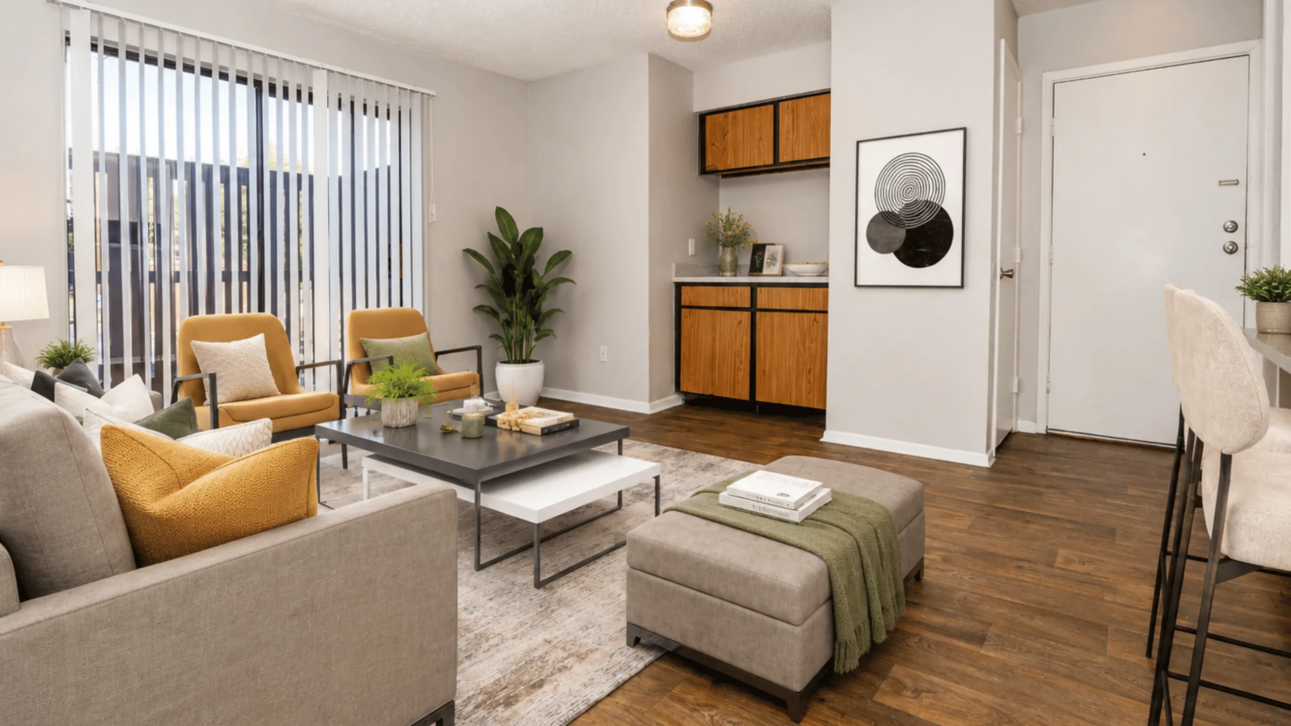 Inviting modern apartment living room with elegant decor, featuring cozy sofas, stylish armchairs, and ample natural light.