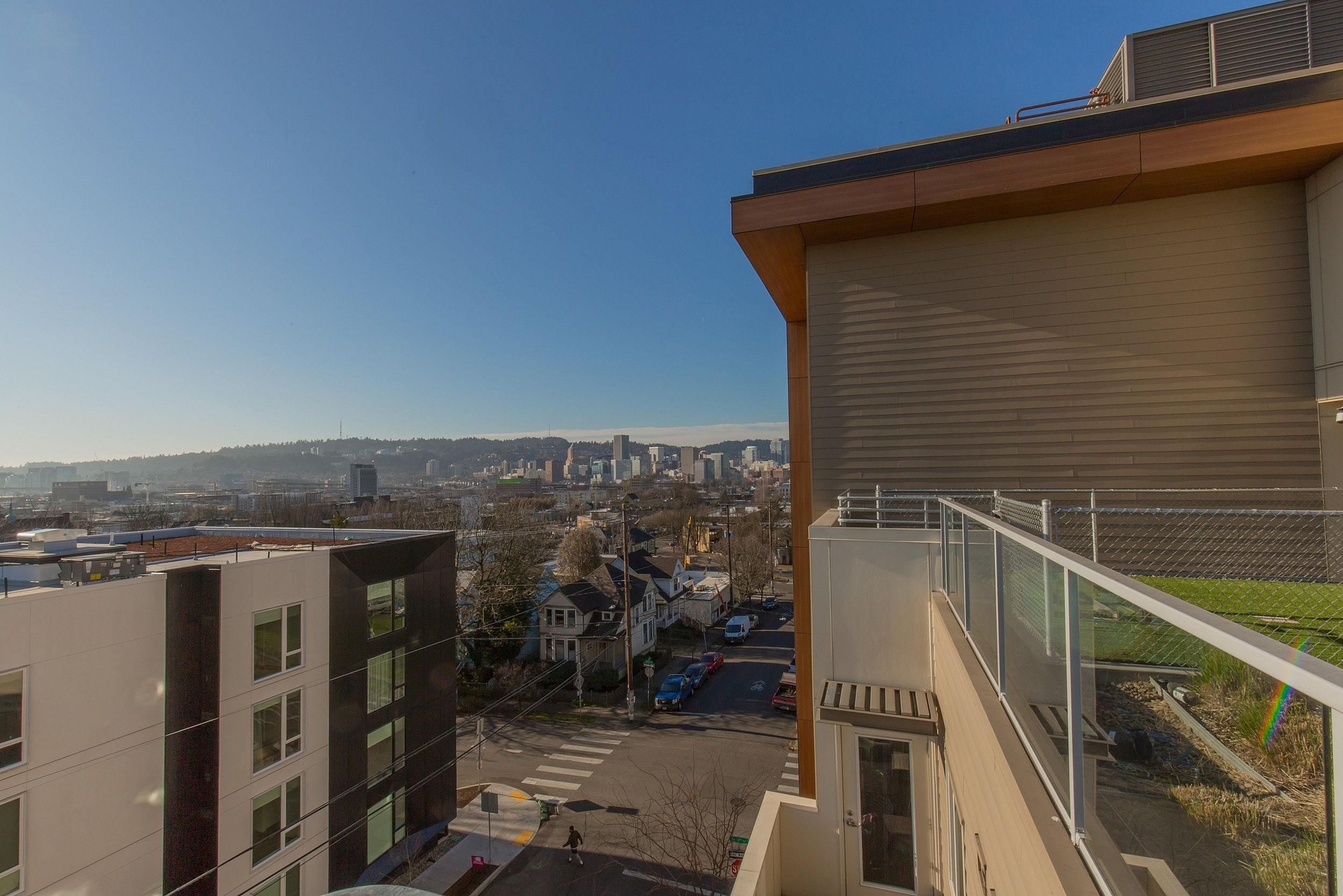 Urban apartment view showcasing a scenic city skyline, modern buildings, and charming neighborhood on a sunny day.