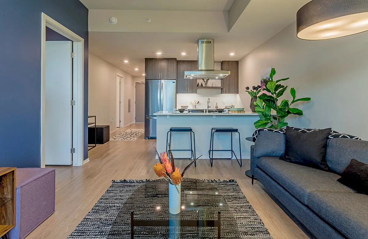 Contemporary open-concept apartment interior with sleek kitchen, stylish living area, and modern décor.