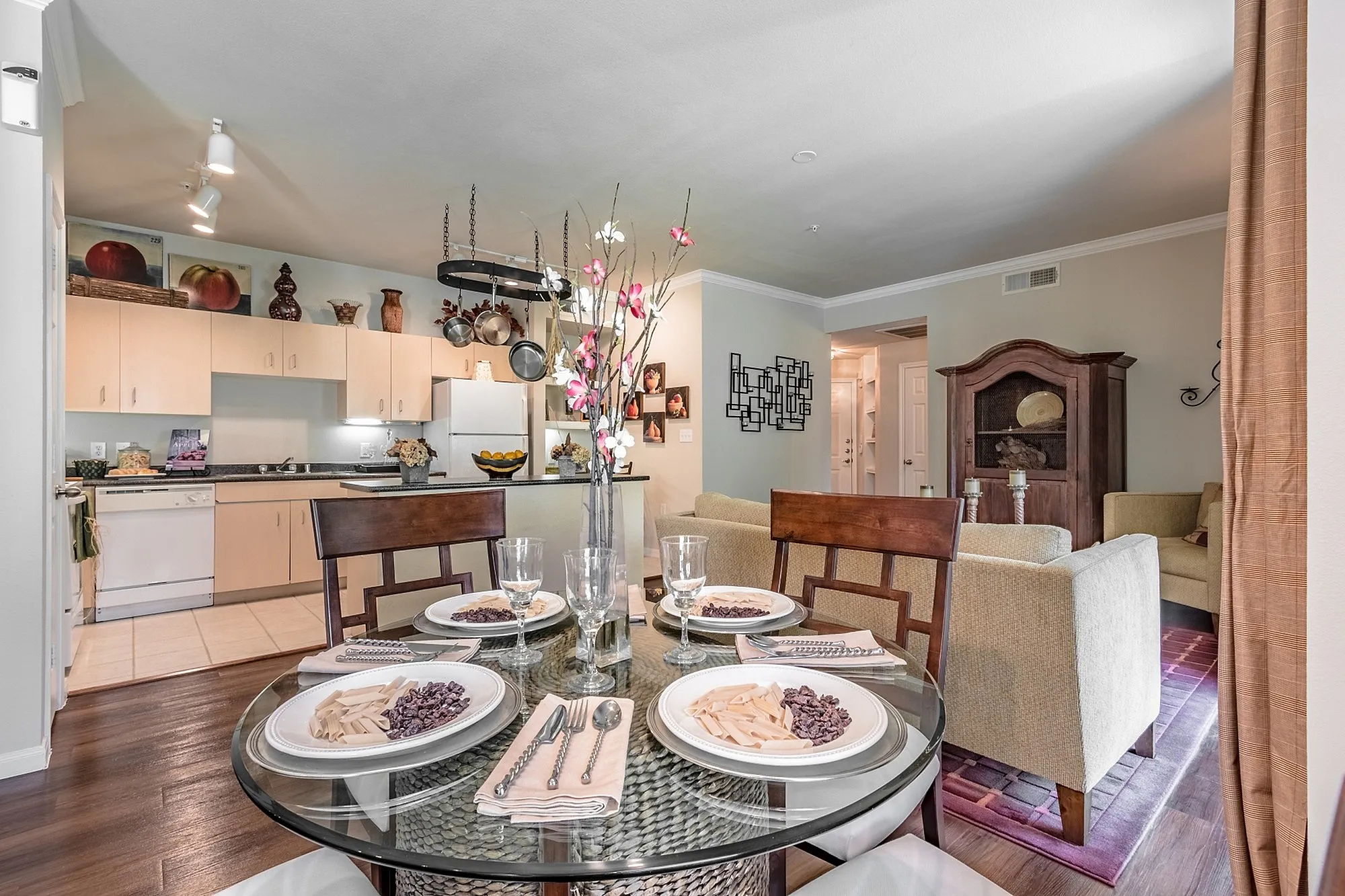 Charming open-plan kitchen and dining area featuring elegant table setting and cozy living room.