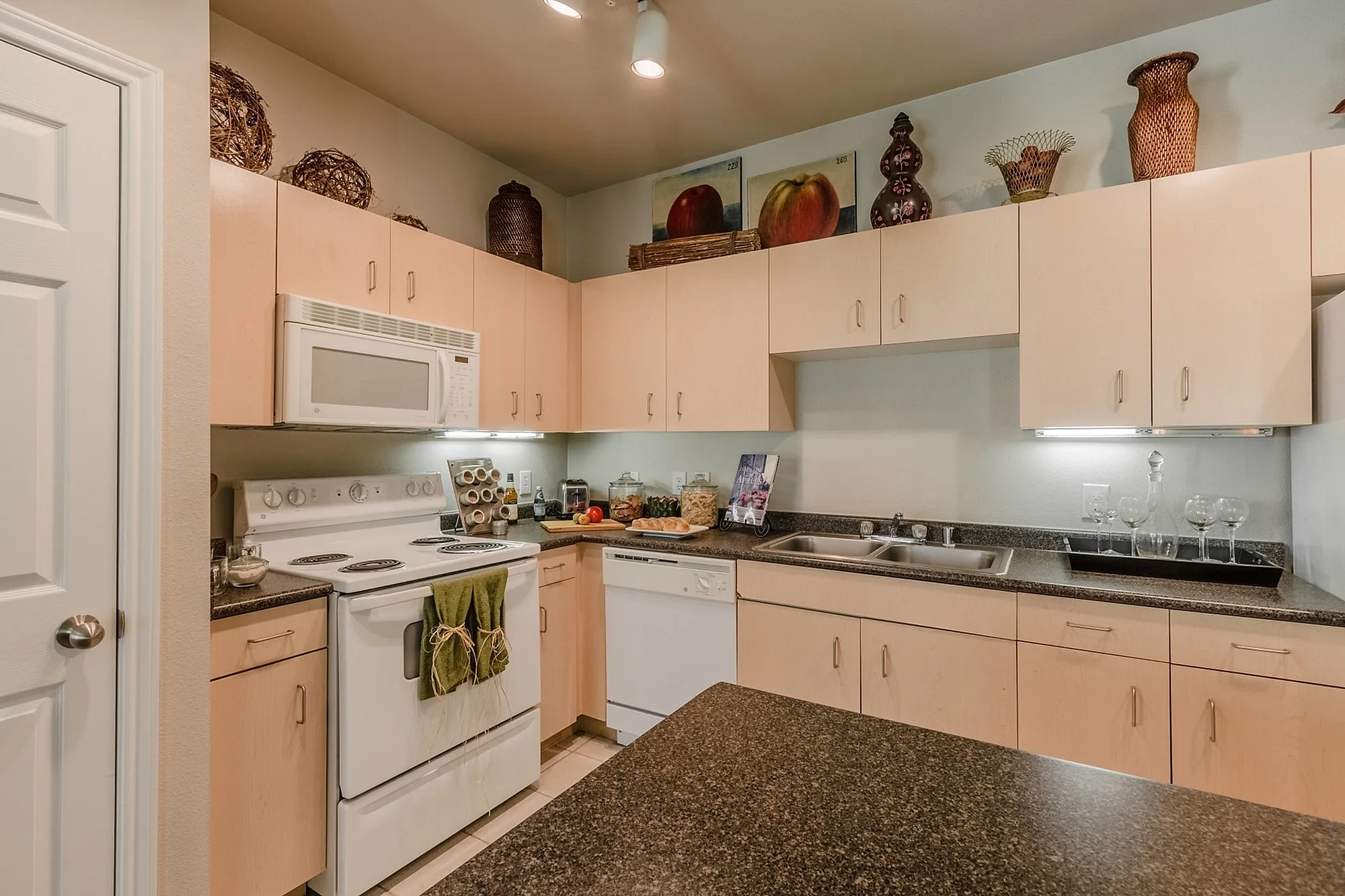 Charming kitchen with modern appliances, ample cabinet space, and elegant decor for a cozy culinary experience.