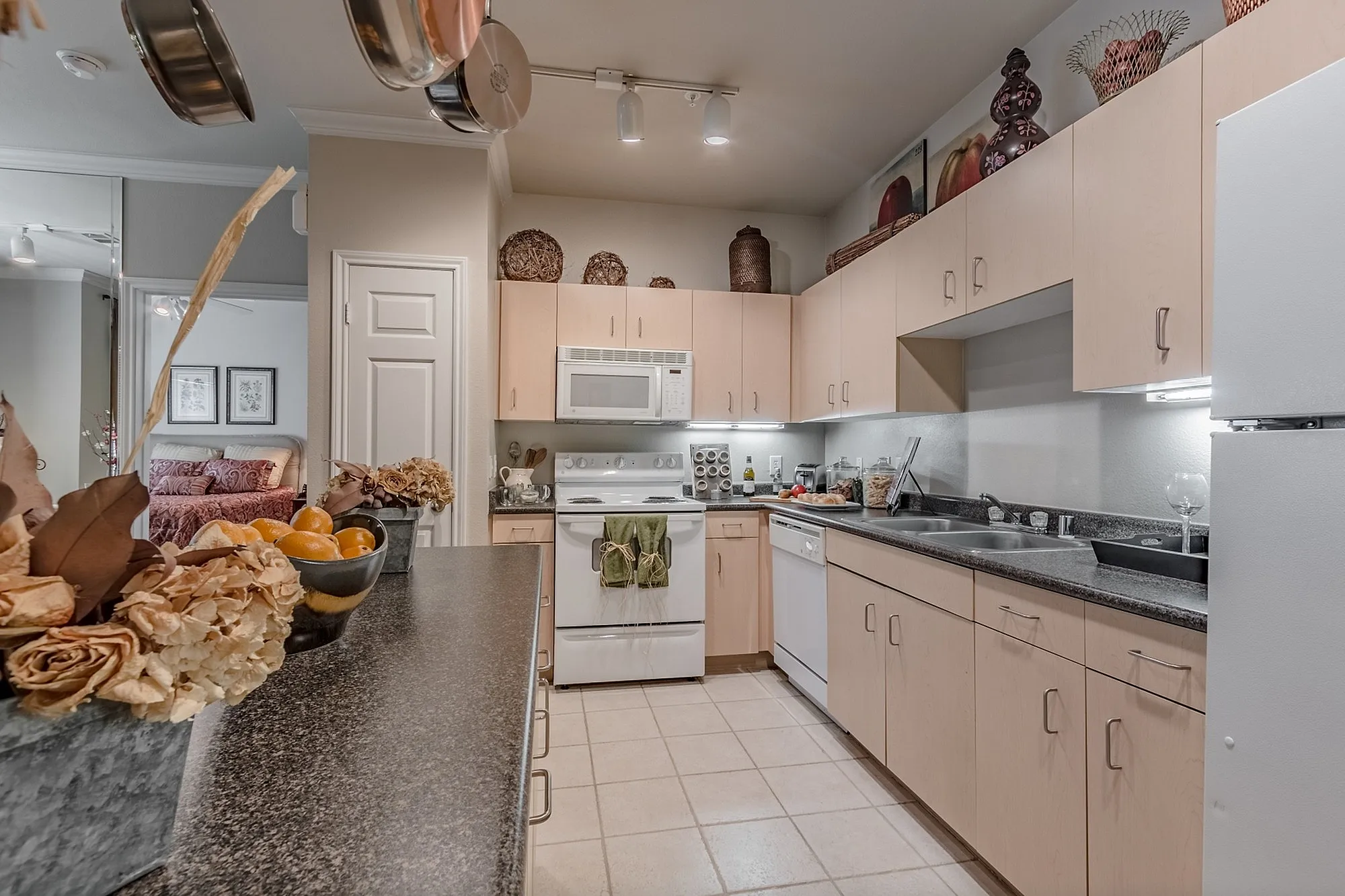 Elegant kitchen with light wood cabinets, modern appliances, and stylish countertops, creating a warm and inviting cooking space.