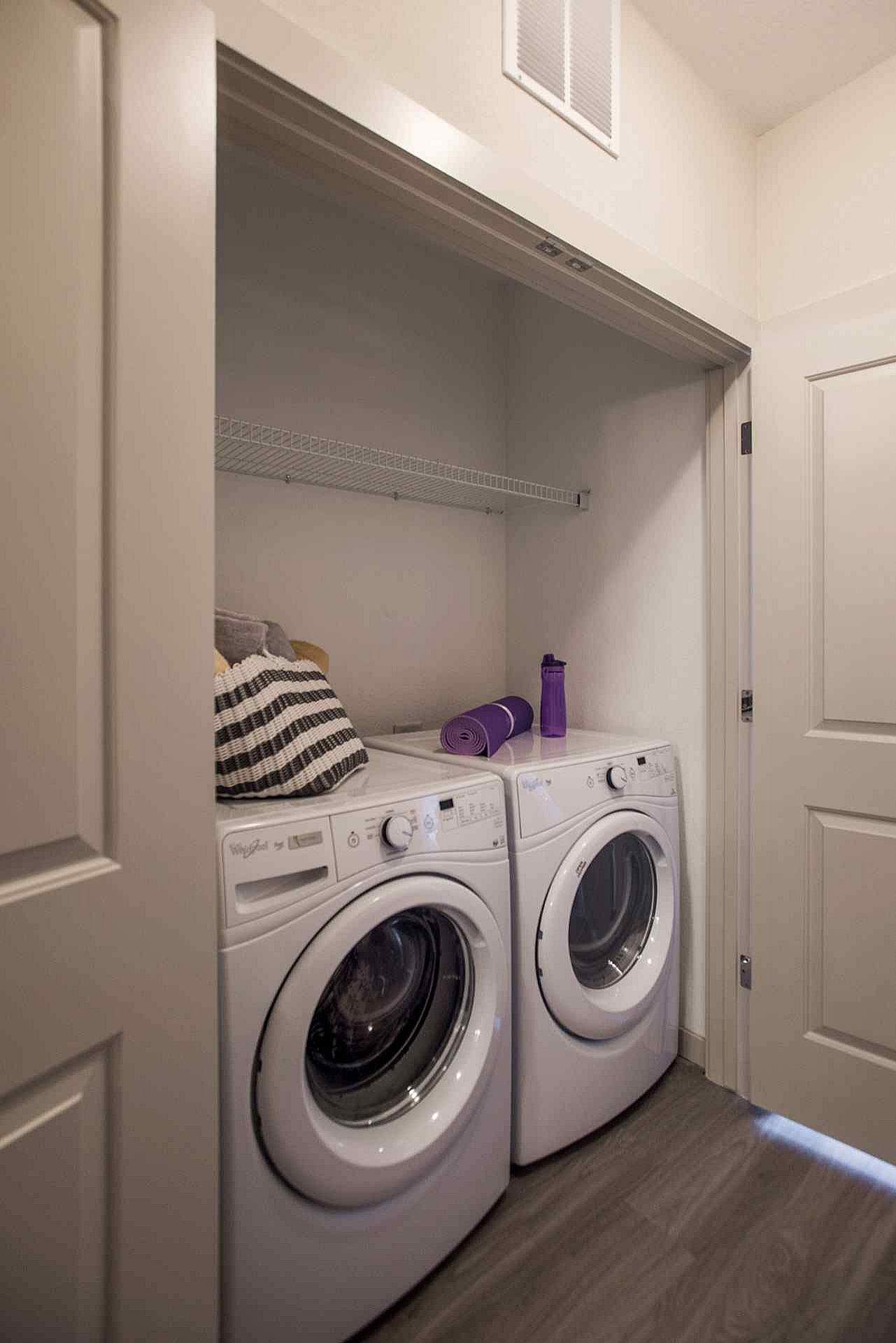 Modern laundry nook with energy-efficient washer and dryer seamlessly integrated into a cozy apartment space.