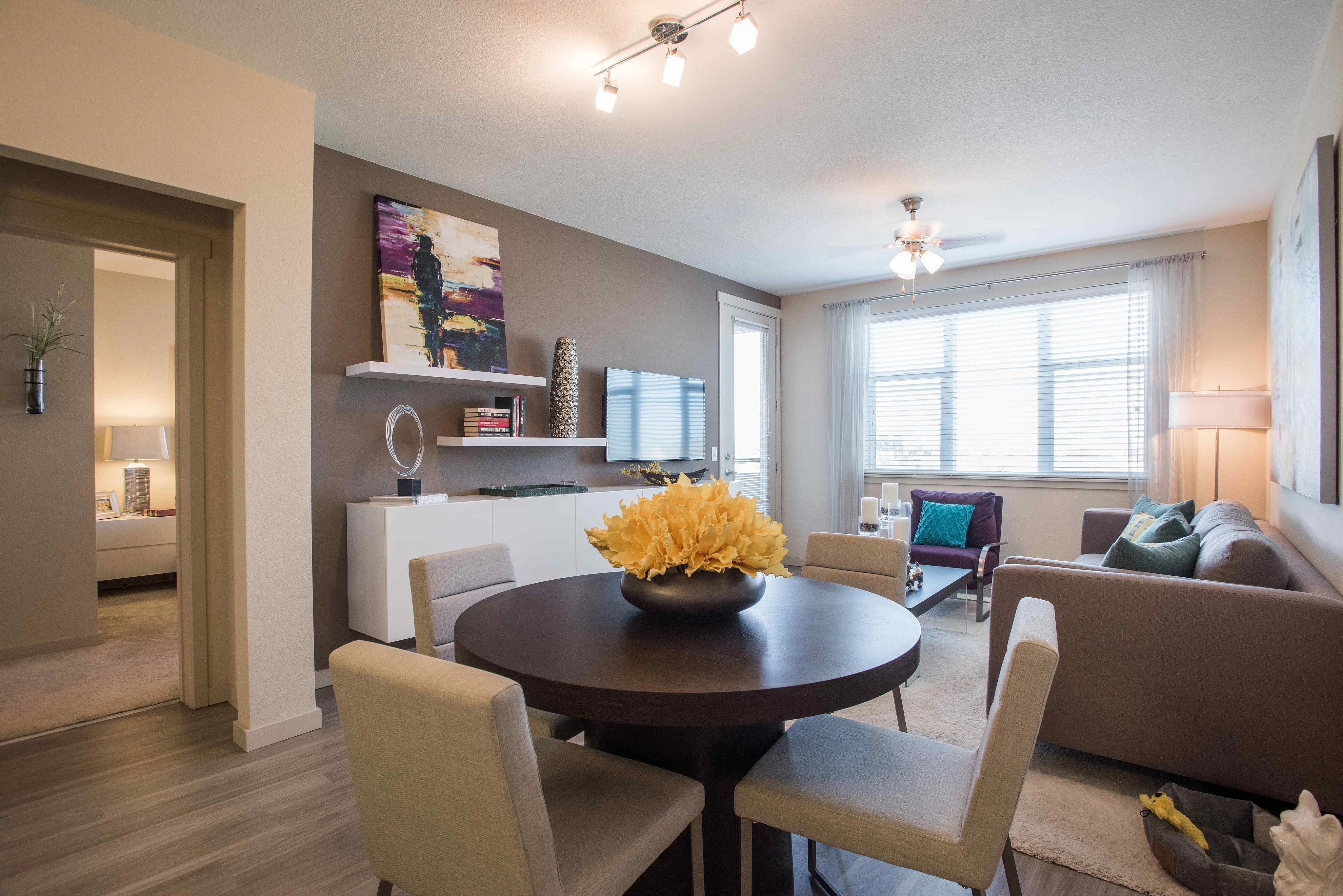 Bright and modern open-plan living room with elegant dining area, stylish decor, and ample natural light.