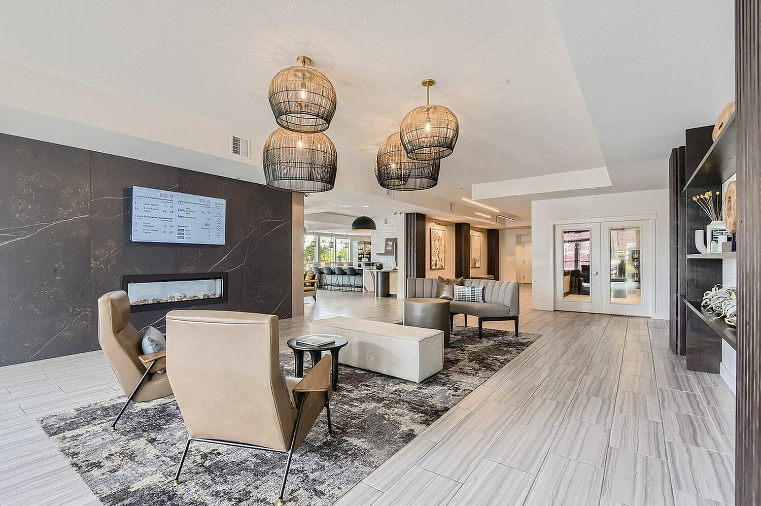 Elegant and modern living area featuring chic chandeliers, stylish seating, and contemporary decor with a bright and inviting atmosphere.