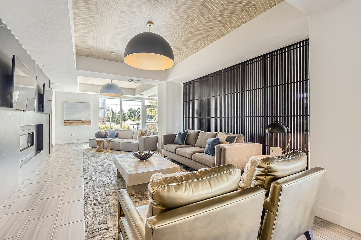 Elegant living room showcasing modern decor with plush sofas, chic lighting, and a cozy fireplace, ideal for relaxation and entertainment.