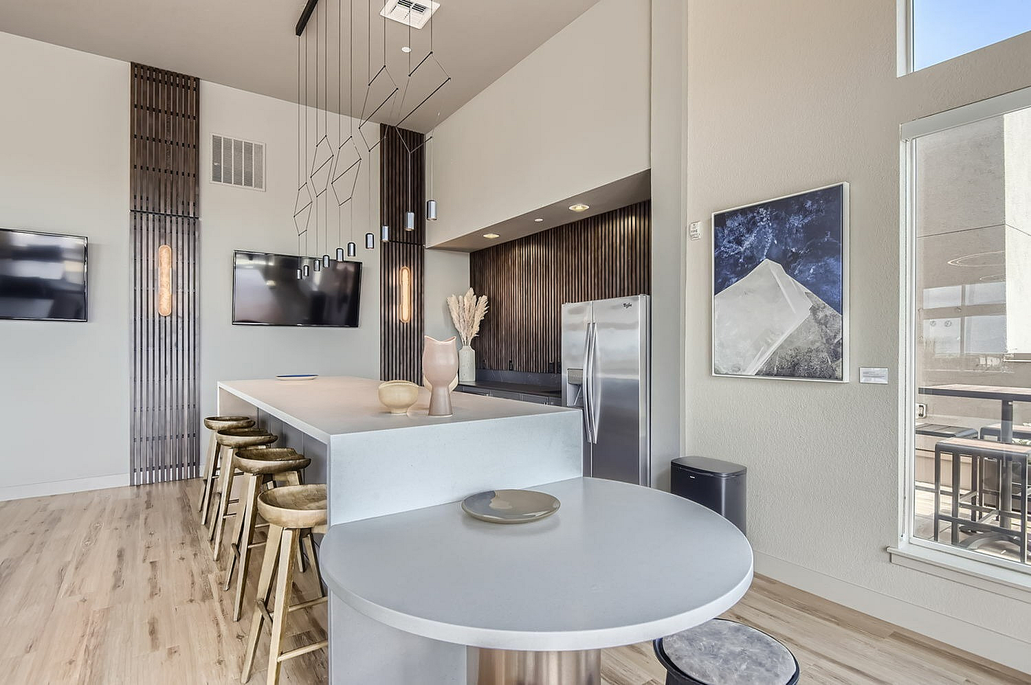 Sophisticated modern kitchen with sleek countertops, stylish pendant lighting, and chic bar stools, perfect for entertaining.